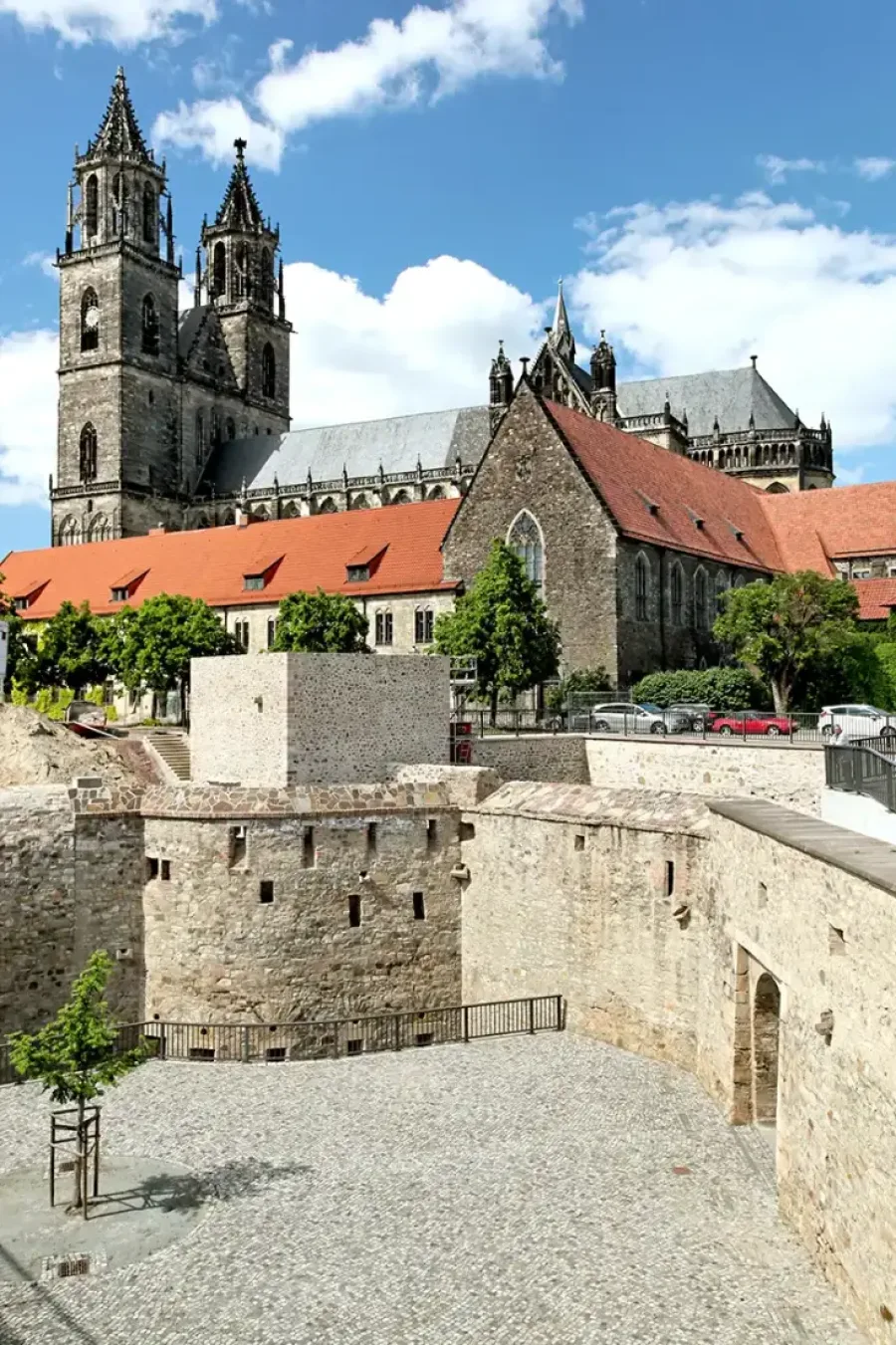 Bastion Cleve mit ihren freigelegten Festungsmauern und dem gepflasterten Innenhof, dahinter die beiden T&uuml;rme des Magdeburger Doms